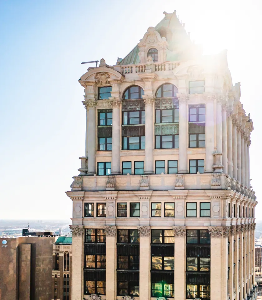 Photo of the top of the tower with the sunlight shining behind it.