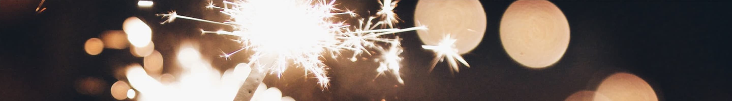 Sparks flying off of a sparkler in dark