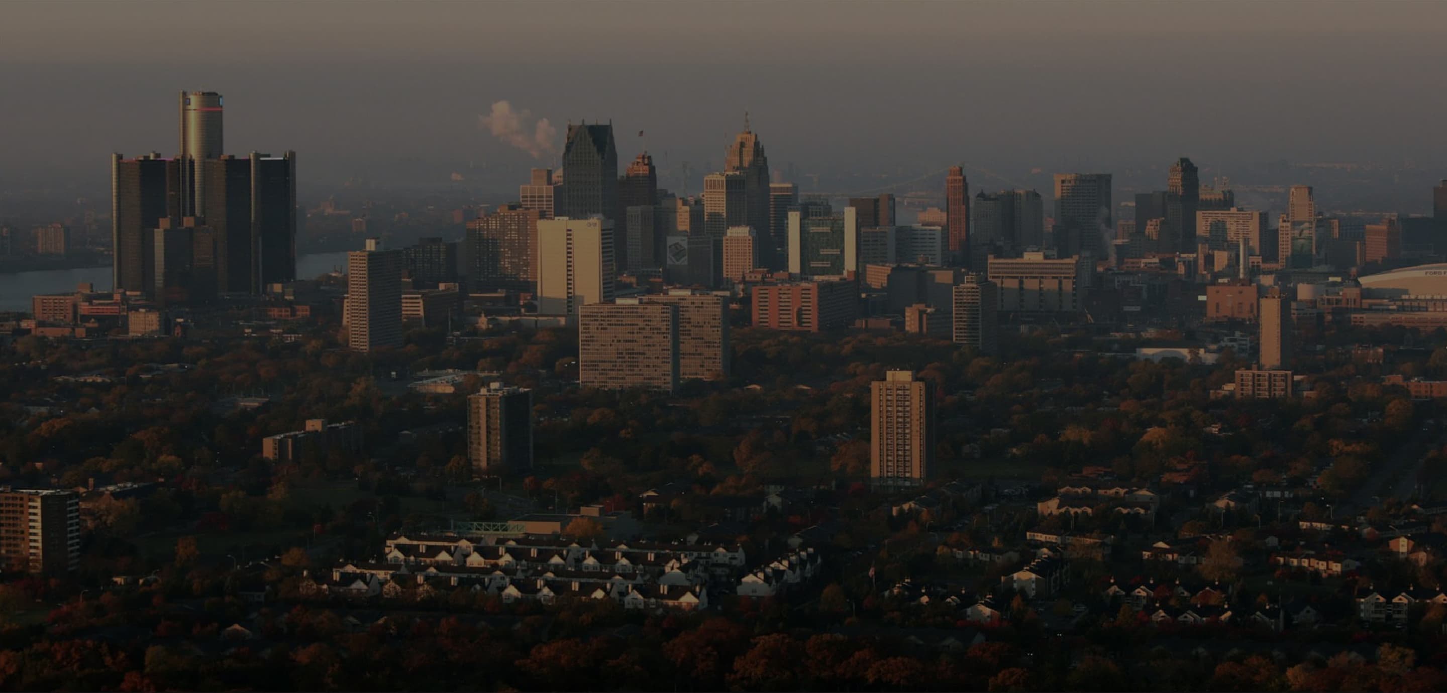 Outlined Brinker logo on top of downtown Detroit skyline.