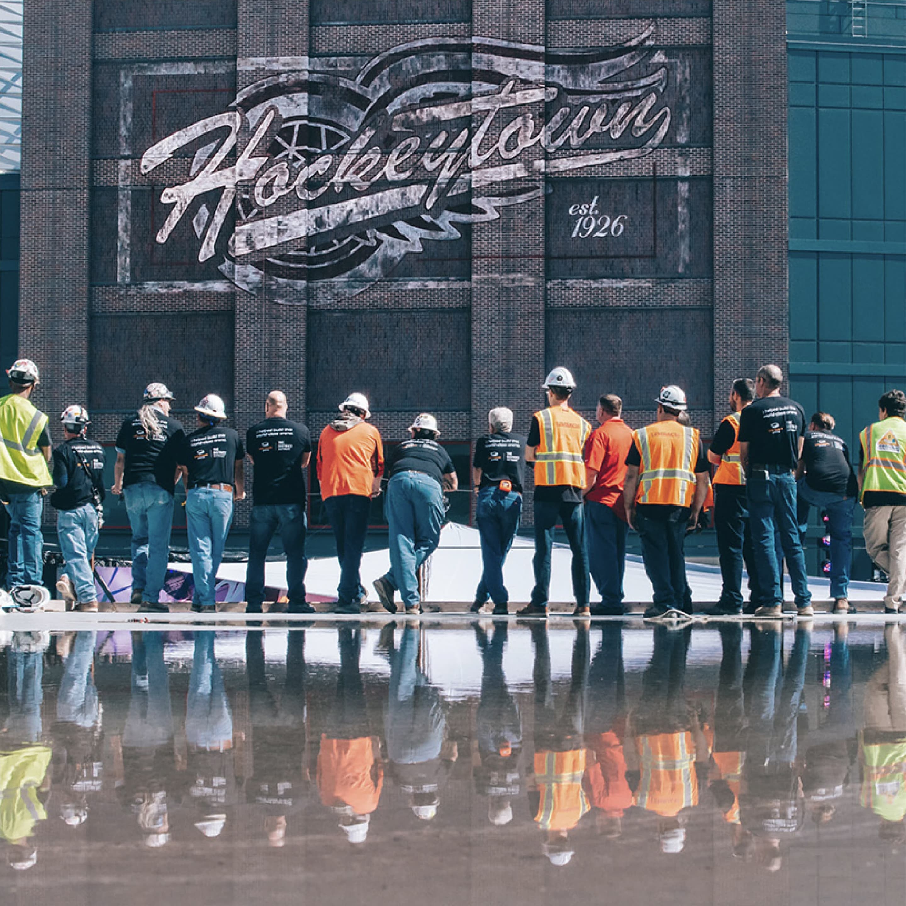 Brinker crew gathered under the Hockeytown mural.