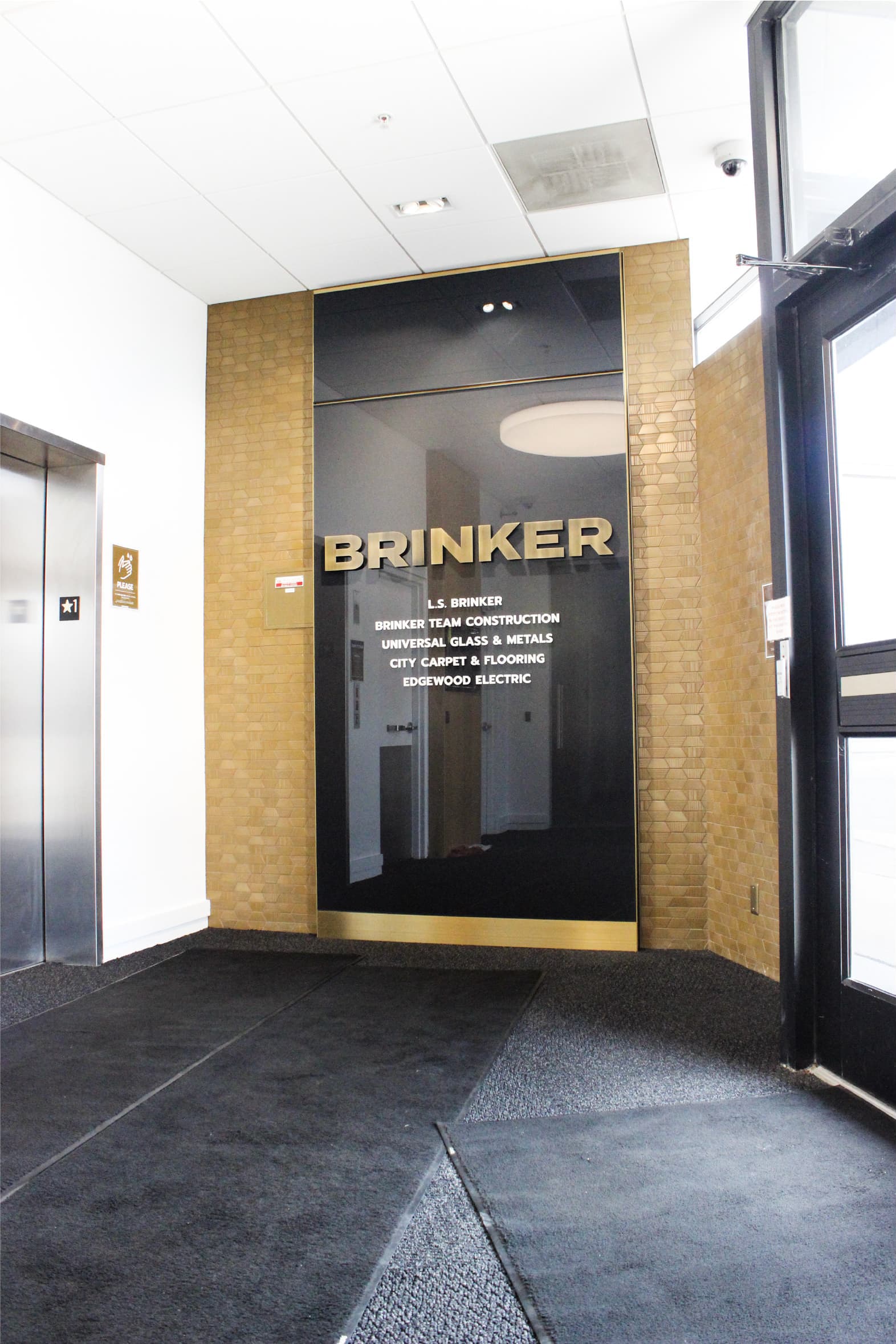 Brinker office lobby with a glass wall with Brinker logo and names of its companies.