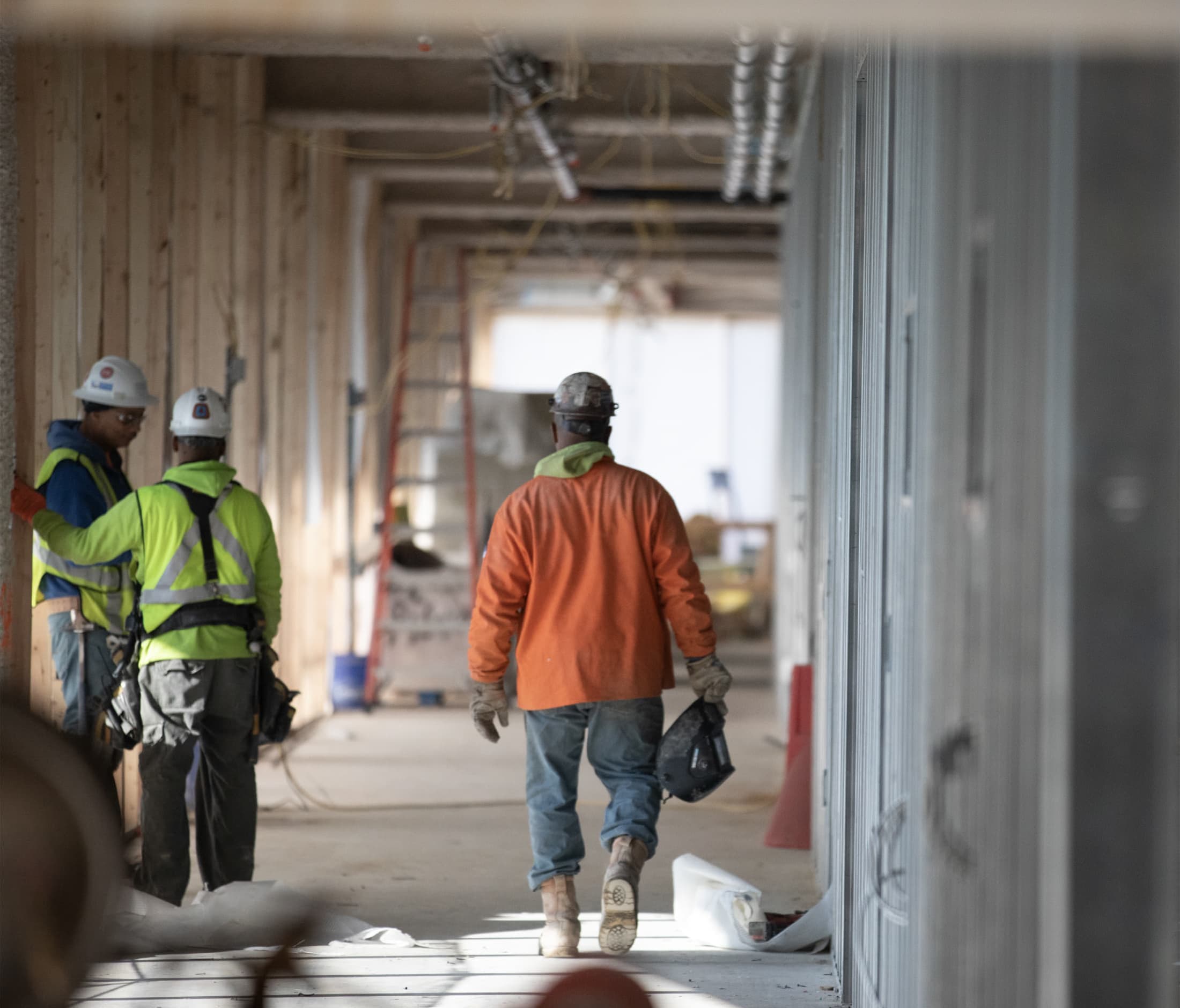 Brinker crew with safety equipment on working in a building under construction.