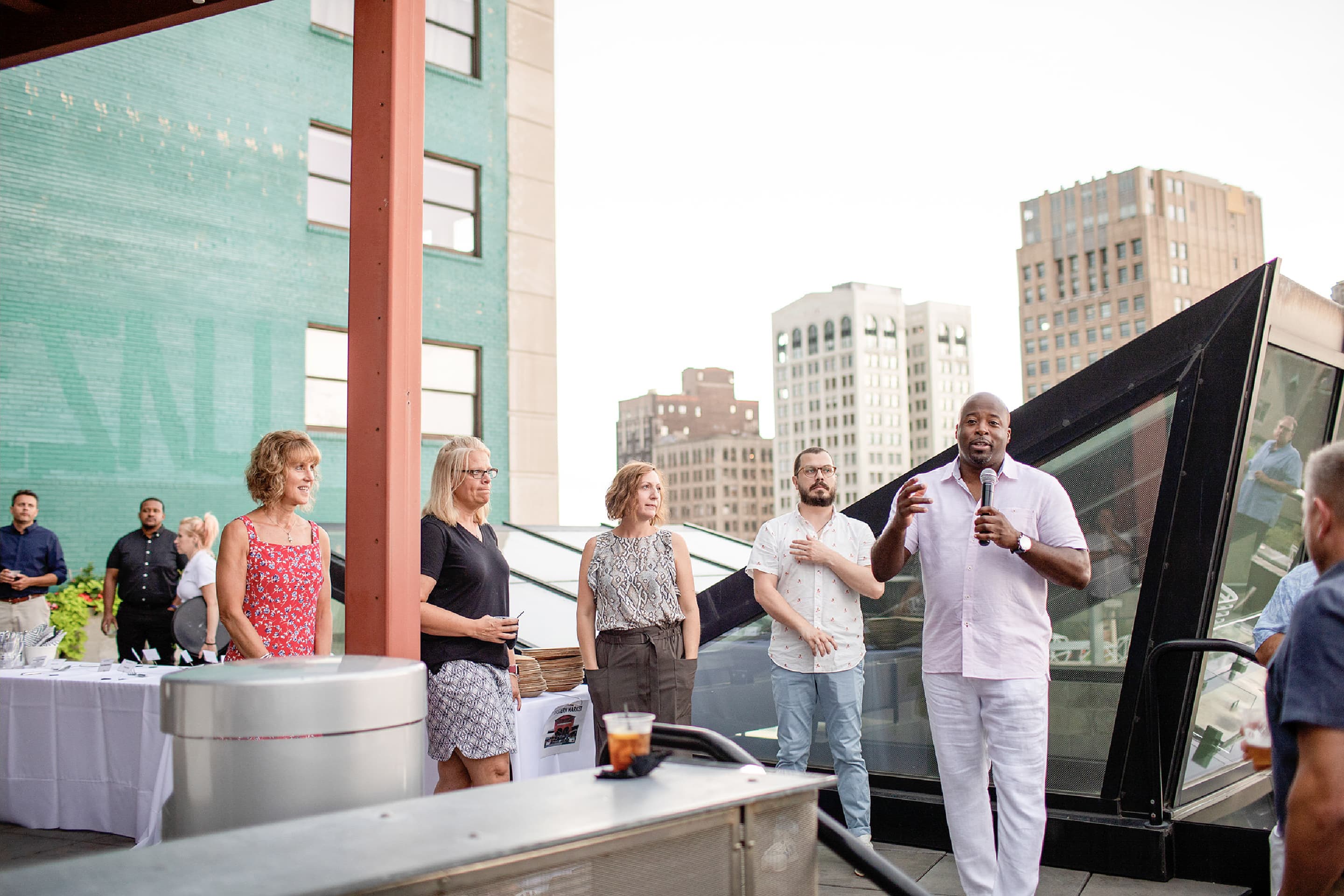 Larry Brinker, Jr. speaking at the new brand launch event held at the rooftop.