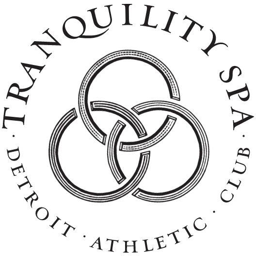 Tranquility Spa brandmark with a 3 interlocking rings elblem in the center with the wordmark around in a circle