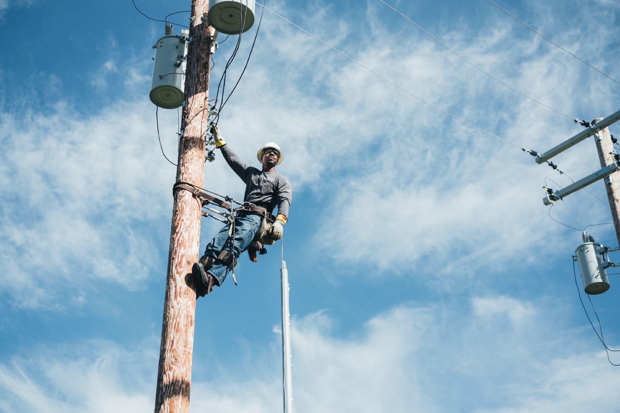 A technician up on a power pole.