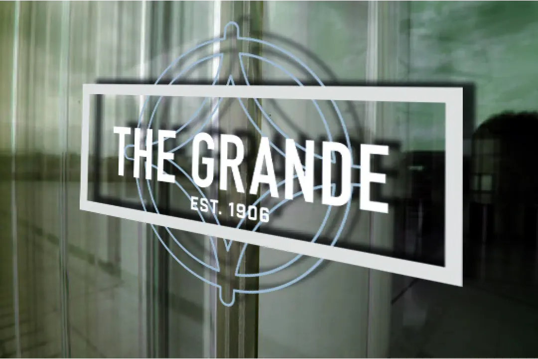 the grande logo on a glass door