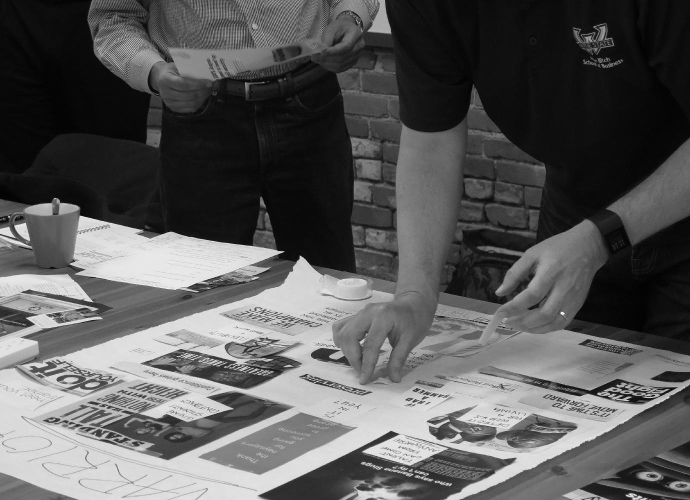 New branding work products being reviewed at a table.