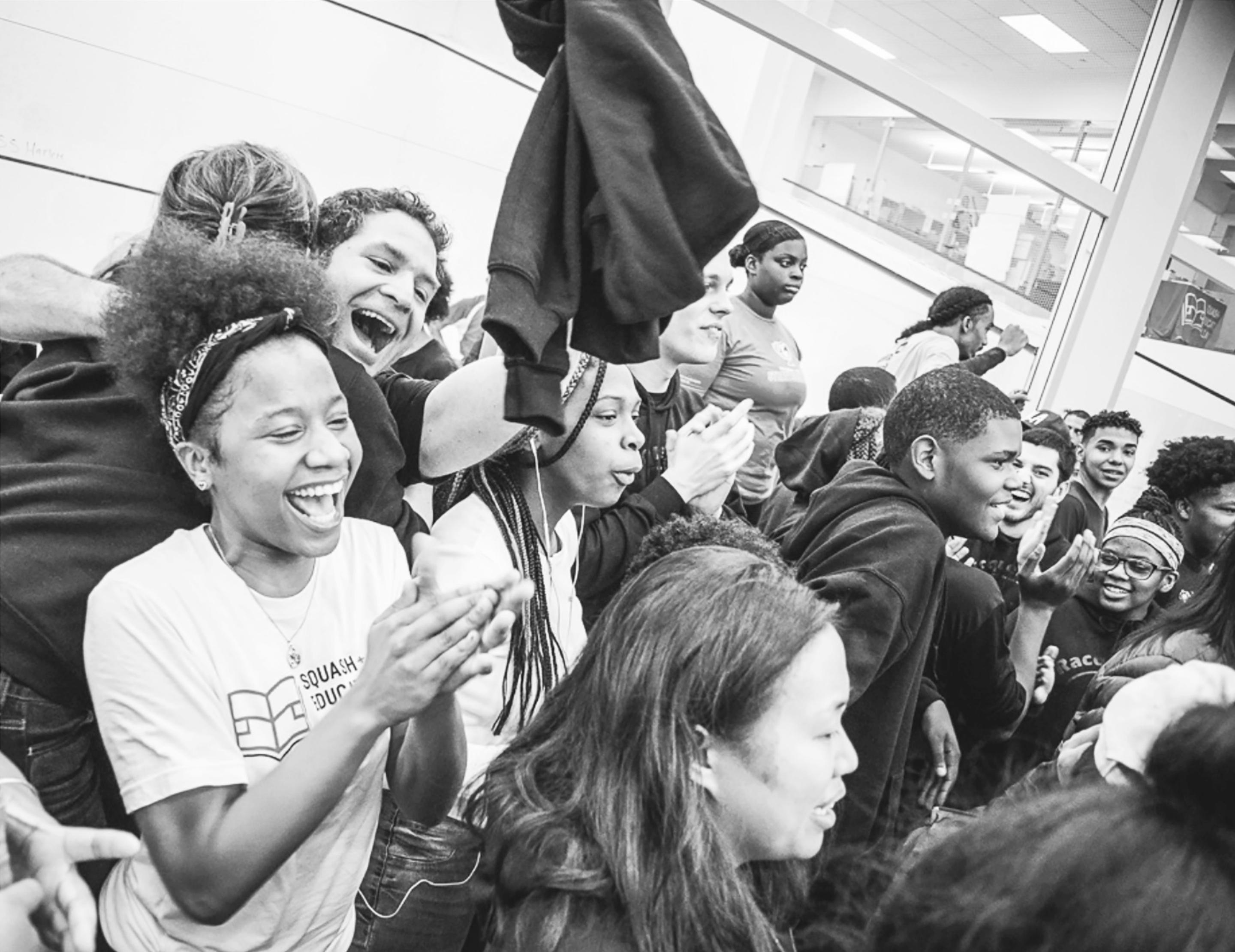 a group of kids cheering on