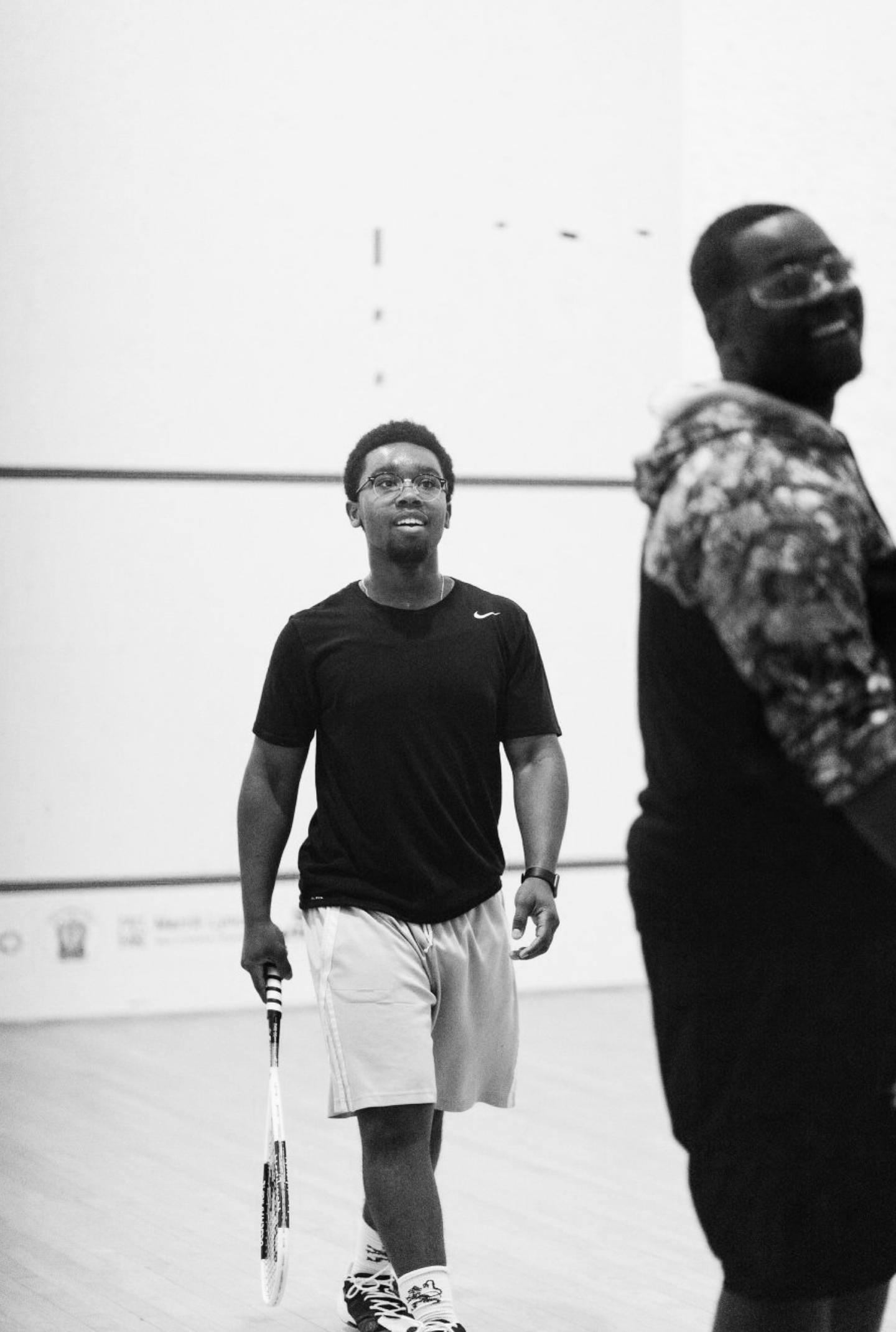 A couple of players in gym clothes getting ready to play a point.