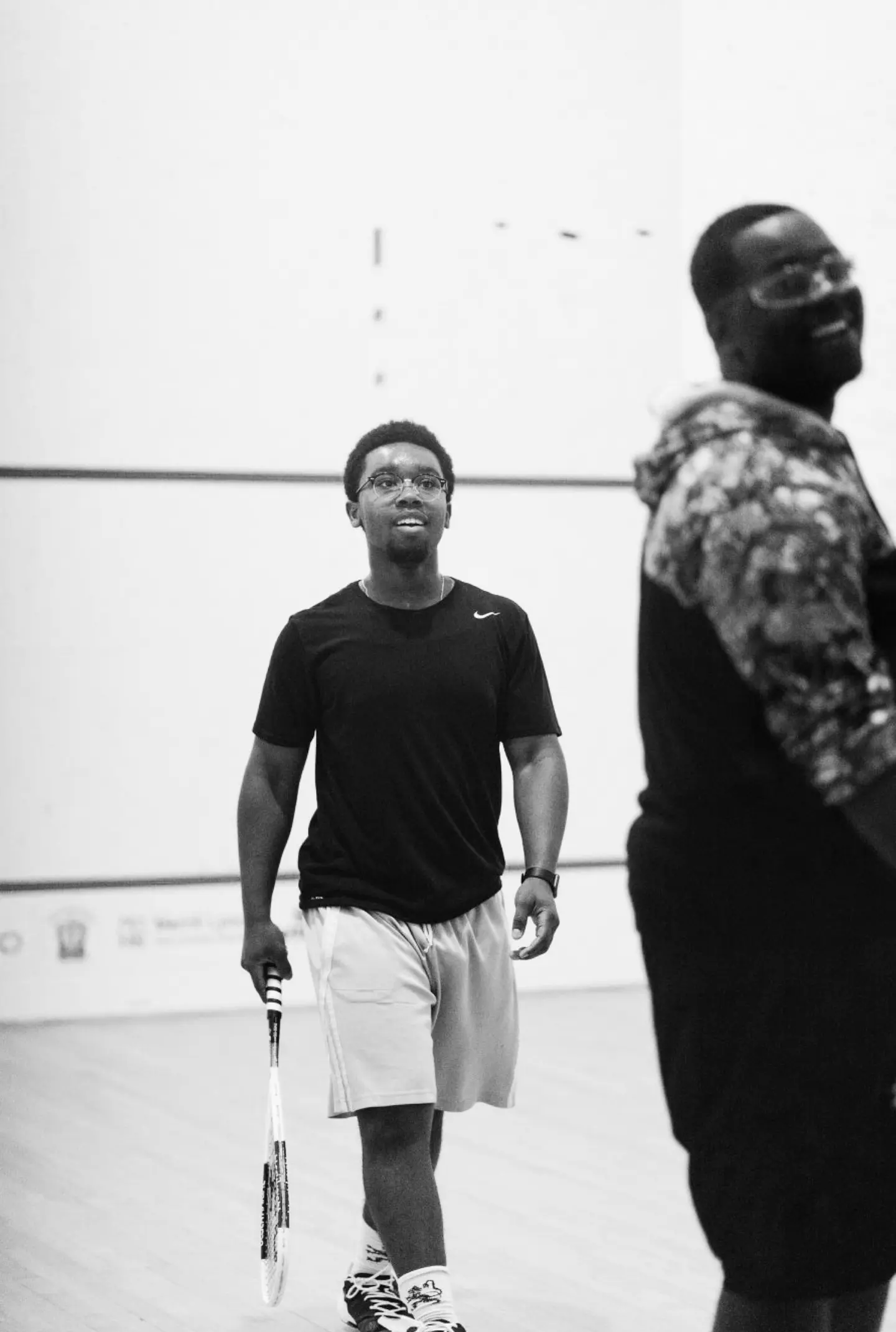 A couple of players in gym clothes getting ready to play a point.