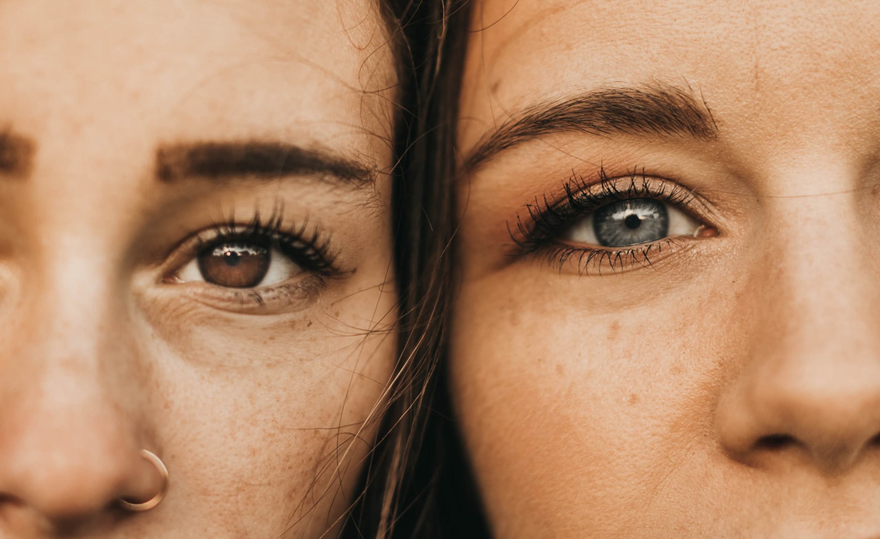 Two diverse young women standing close to each other and smiling